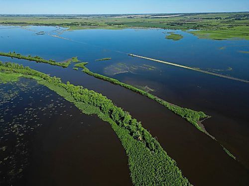 25062026
Flood waters from the swollen Assiniboine River cover farmland and submerge portions of a grid road bisecting Highway 250 north of Alexander on Thursday. 
(Tim Smith/The Brandon Sun)default