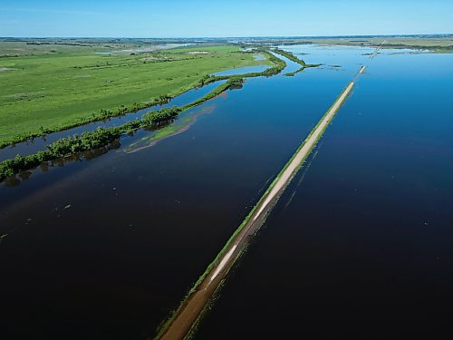 25062026
Flood waters from the swollen Assiniboine River cover farmland and submerge portions of a grid road bisecting Highway 250 north of Alexander on Thursday.
(Tim Smith/The Brandon Sun)default