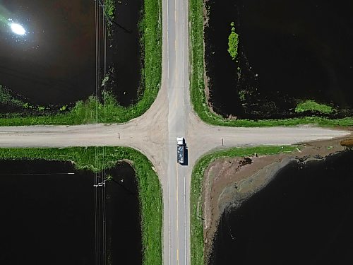 25062026
Flood waters from the swollen Assiniboine River cover farmland and submerge portions of a grid road bisecting Highway 250 north of Alexander on Thursday.
(Tim Smith/The Brandon Sun)default