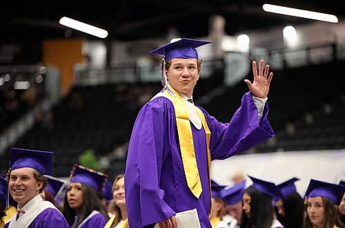 25062026
A graduate waves to supporters after receiving his diploma  during Vincent Massey High School’s class of 2026 graduation ceremony at Assiniboine Credit Union Place on Thursday. 
 (Tim Smith/The Brandon Sun)