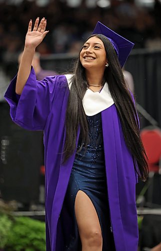 25062026
Jailene Rapalo waves to supporters while walking up to receive her diploma during the Vincent Massey High School class of 2026 graduation ceremony at Assiniboine Credit Union Place on Thursday. 
 (Tim Smith/The Brandon Sun)