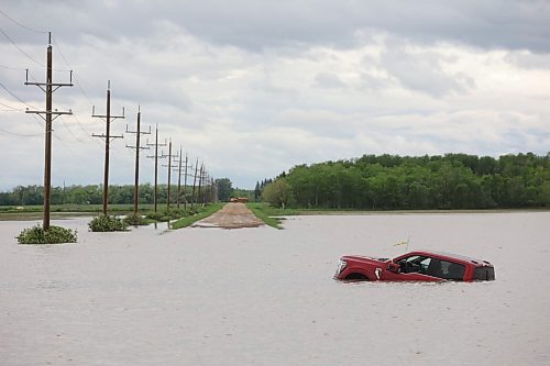 10062026
A pickup trucks sits partially submerged in floodwaters along Highway 83 south of Swan River, Manitoba on Wednesday after sustained rainfall earlier in the week caused widespread flooding. (Tim SmithThe Brandon Sun)