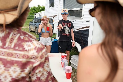 Beckham Clarke of Virden throws a ping-pong ball while playing beer pong with friends during Dauphin’s Countryfest 2026 on Friday. (Tim Smith/The Brandon Sun)
