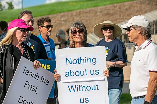 BROOK JONES/FREE PRESS
People gather outside the Canadian Museum for Human Rights to protest a new exhibit, Palestine Uprooted - Nakba Past and Present at the CMHR in Winnipeg, Man., Friday, June 26, 2026. Pictured: Gail Asper (middle), whose late father Izzy Asper founded the museum, holds a sign.