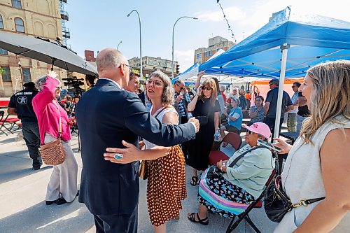 MIKE DEAL / FREE PRESS
Ginette Lavack MP for St. Boniface—St. Vital is greeted by Mayor Scott Gillingham before the grand opening of the plaza outside the Burton Cummings Theatre named after her late husband Kevin Walters, Friday afternoon.
Standup
260626 - Friday, June 26, 2026.