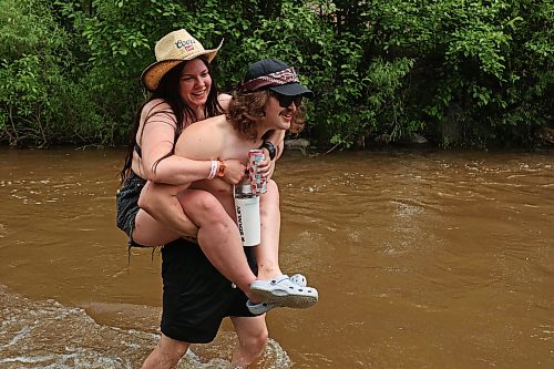 26062026
Sebastian Pulak gives Eliese Schwennesen a piggyback ride across the creek that runs past the campground area at Dauphin’s Countryfest 2026 on Friday afternoon.
(Tim Smith/The Brandon Sun)