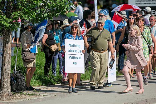 BROOK JONES/FREE PRESS
People gather outside the Canadian Museum for Human Rights to protest a new exhibit, Palestine Uprooted - Nakba Past and Present at the CMHR in Winnipeg, Man., Friday, June 26, 2026. Pictured: Gail Asper, whose late father Izzy Asper founded the museum, holds a sign.