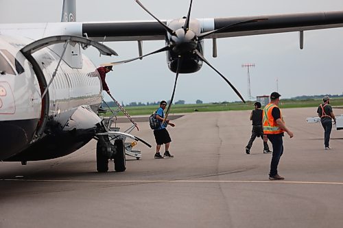 Evacuees from Lynn Lake arrive at the Brandon Municipal Airport on Saturday evening after being forced from their homes for the third time in the last one year. (Abiola Odutola/The Brandon Sun)