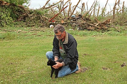29062026
Brian Brown holds his cat Johnson after finding the cat under his home south of Rossburn, Manitoba on Monday after a powerful tornado hit the property on Sunday evening while Brian was at home with his wife Bernadine. Their home, several other buildings on the property, vehicles and hundreds of trees were all heavily damaged by the tornado. All of the Brown’s three house cats were found safe.
(Tim Smith/The Brandon Sun)