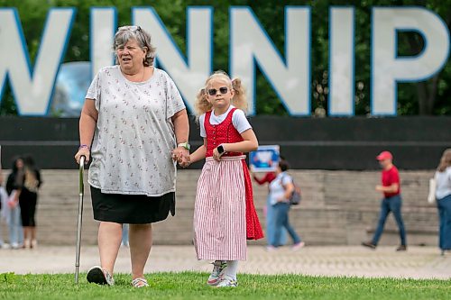 BROOK JONES/FREE PRESS
Canada Day festivities and a citizenship ceremony take place at The Forks in Winnipeg, Man., Wednesday, July 1, 2026. Vera Neufeld (left), who is a third generation Canadian, is pictured with her eight-year-old granddaughter Rory Neufeld Canada Day celebration with his wife Stephanie and their other son Waller. Rory's mother is an adult ambassador with the German Pavilion during Folklorama.