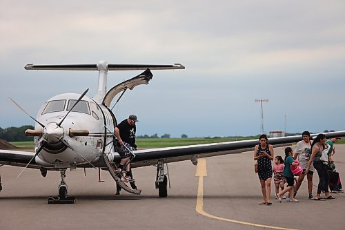 Evacuees from Lynn Lake arrive at the Brandon Municipal Airport on Saturday evening after being forced from their homes for the third time in the last one year. (Abiola Odutola/The Brandon Sun)
