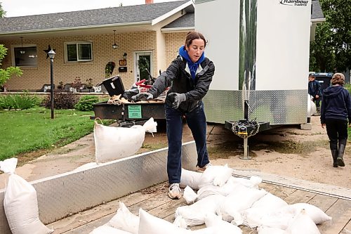 02072026
Britney Warkentin loads sandbags no longer needed by Angela and Devin Shtykalo for their home in Dauphin, onto a trailer to use to protect her father’s cottage along Dauphin Lake at Ochre Beach on Thursday. Several homes along the Vermillion river in Dauphin were flooded earlier this week and homes and cottages at Dauphin Lake are at risk of flooding as the lake level continues to rise. (Tim Smith/The Brandon Sun)