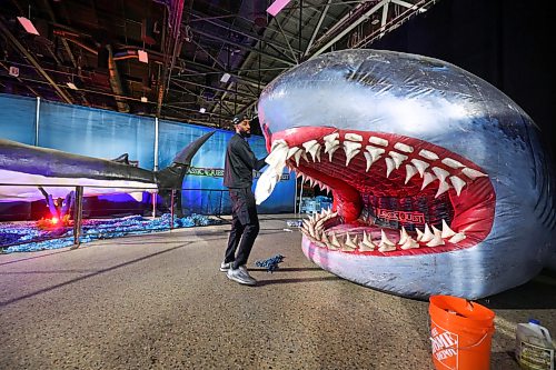 Ruth Bonneville / Free Press

Standup Jurassic Quest

Marcellus Dunn, who’s part of the set-up and customer service team with Jurassic Quest, makes sure the mouth of the giant shark that kids can play in is clean just prior to the doors opening Friday. 

Jurassic Quest is an immersive featuring over 100 life-sized, photorealistic animatronic dinosaurs alongside interactive activities like fossil digs, dinosaur rides, and themed bounce houses for all ages.  The event runs from July 3-5 at the RBC Convention Centre

July 3rd,  2026