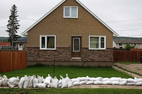 03062026
Sandbags line a sidewalk in front of homes in Minnedosa on Friday as part of potential flood preparations. The Little Saskatchewan River is expected to continue to rise as water from all the recent rains in the area makes its way into the river and downstream.
(Tim Smith/The Brandon Sun)
