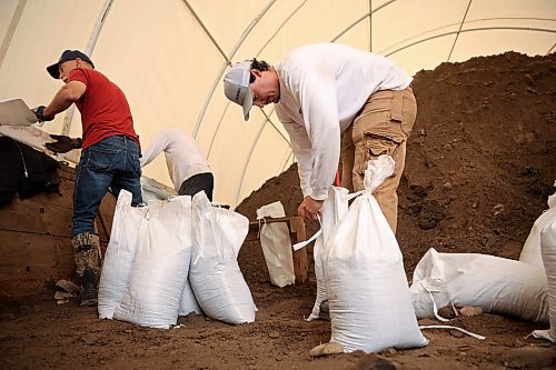 03062026
Dexter Dalgleish helps fill sandbags with other volunteers in Minnedosa on Friday as part of potential flood preparations. The Little Saskatchewan River is expected to continue to rise as water from all the recent rains in the area makes its way into the river and downstream.
(Tim Smith/The Brandon Sun)
