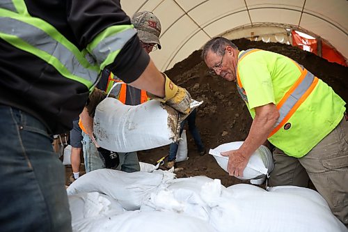 03062026
Volunteers and public works staff work to fill sandbags in Minnedosa on Friday as part of potential flood preparations. The Little Saskatchewan River is expected to continue to rise as water from all the recent rains in the area makes its way into the river and downstream.
(Tim Smith/The Brandon Sun)