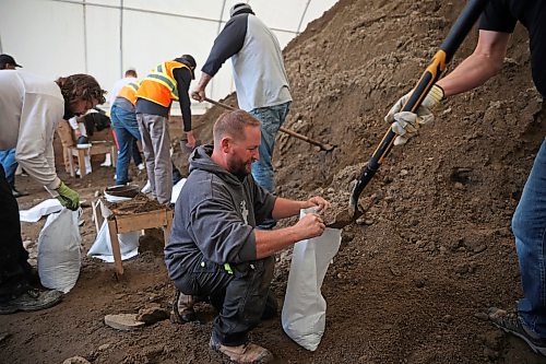 03062026
Volunteers and public works staff work to fill sandbags in Minnedosa on Friday as part of potential flood preparations. The Little Saskatchewan River is expected to continue to rise as water from all the recent rains in the area makes its way into the river and downstream.
(Tim Smith/The Brandon Sun)