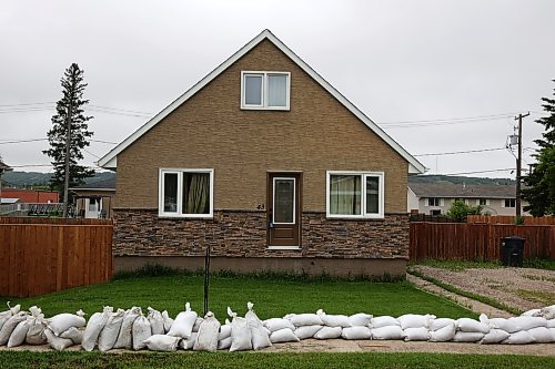 03062026
Sandbags line a sidewalk in front of homes in Minnedosa on Friday as part of potential flood preparations. The Little Saskatchewan River is expected to continue to rise as water from all the recent rains in the area makes its way into the river and downstream.
(Tim Smith/The Brandon Sun)