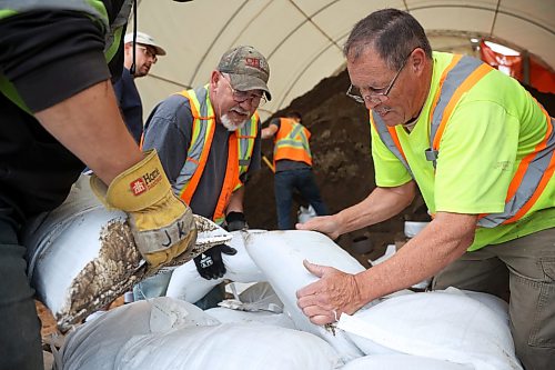 03062026
Volunteers and public works staff work to fill sandbags in Minnedosa on Friday as part of potential flood preparations. The Little Saskatchewan River is expected to continue to rise as water from all the recent rains in the area makes its way into the river and downstream.
(Tim Smith/The Brandon Sun)