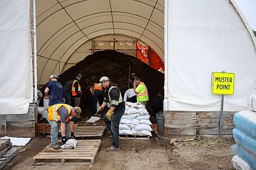 03062026
Volunteers and public works staff work to fill sandbags in Minnedosa on Friday as part of potential flood preparations. The Little Saskatchewan River is expected to continue to rise as water from all the recent rains in the area makes its way into the river and downstream.
(Tim Smith/The Brandon Sun)