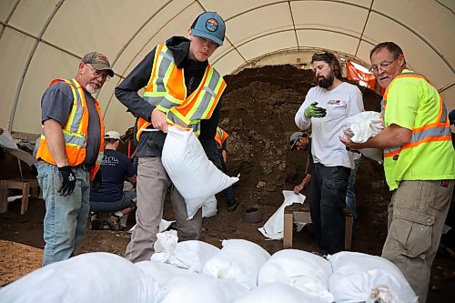 03062026
Volunteers and public works staff work to fill sandbags in Minnedosa on Friday as part of potential flood preparations. The Little Saskatchewan River is expected to continue to rise as water from all the recent rains in the area makes its way into the river and downstream.
(Tim Smith/The Brandon Sun)