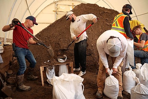 03062026
Volunteers and public works staff work to fill sandbags in Minnedosa on Friday as part of potential flood preparations. The Little Saskatchewan River is expected to continue to rise as water from all the recent rains in the area makes its way into the river and downstream.
(Tim Smith/The Brandon Sun)