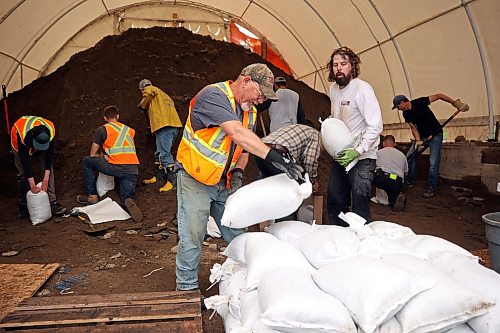 03062026
Volunteers and public works staff work to fill sandbags in Minnedosa on Friday as part of potential flood preparations. The Little Saskatchewan River is expected to continue to rise as water from all the recent rains in the area makes its way into the river and downstream.
(Tim Smith/The Brandon Sun)