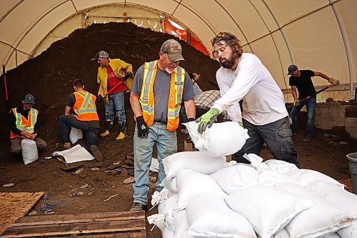 03062026
Volunteers and public works staff work to fill sandbags in Minnedosa on Friday as part of potential flood preparations. The Little Saskatchewan River is expected to continue to rise as water from all the recent rains in the area makes its way into the river and downstream.
(Tim Smith/The Brandon Sun)