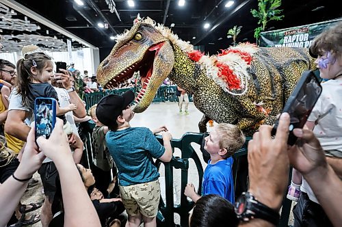JOHN WOODS / FREE PRESS
Jacob takes it all in stride as Diego the dino tries to steal his cap and has fun with him and children during the Jurassic Quest at the Convention Centre Monday, July 5, 2026. 

reporter: standup