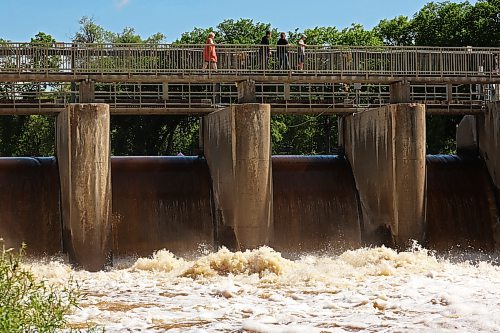 Visitors to the Minnedosa Lake dam pass over the spillway on Monday as water pours into the Little Saskatchewan River at an increased volume due to all the recent rain. (Photos by Tim Smith/The Brandon Sun)
