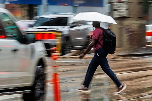 MIKE DEAL / FREE PRESS
Umbrellas were deployed against the wet weather for Monday morning commuters in downtown Winnipeg.
Standup
260706 - Monday, July 06, 2026.