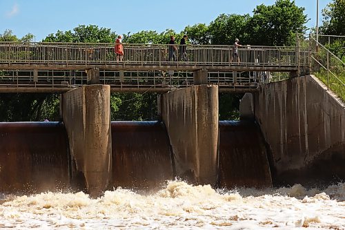 06072026
Visitors to the Minnedosa Lake dam pass over the spillway as water pours into the Little Saskatchewan River at an increased volume due to all the recent rain. 
(Tim Smith/The Brandon Sun)