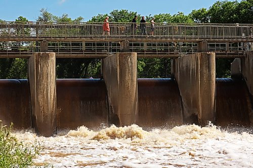 06072026
Visitors to the Minnedosa Lake dam pass over the spillway as water pours into the Little Saskatchewan River at an increased volume due to all the recent rain. 
(Tim Smith/The Brandon Sun)