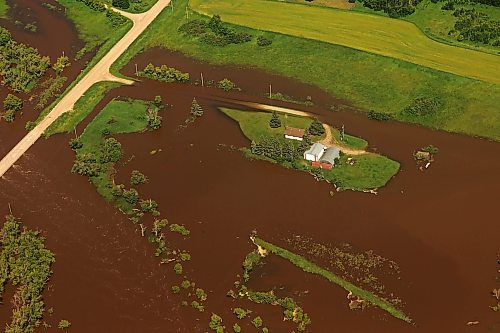06072026
A home and farm sit on an island of dry land, surrounded by the floodwaters of the swollen Assiniboine River just west of Russell, Manitoba, as seen from the air on Monday. (Tim Smith/The Brandon Sun)