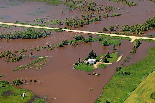 06072026
A home and farm sit on an island of dry land, surrounded by the floodwaters of the swollen Assiniboine River just west of Russell, Manitoba, as seen from the air on Monday. (Tim Smith/The Brandon Sun)