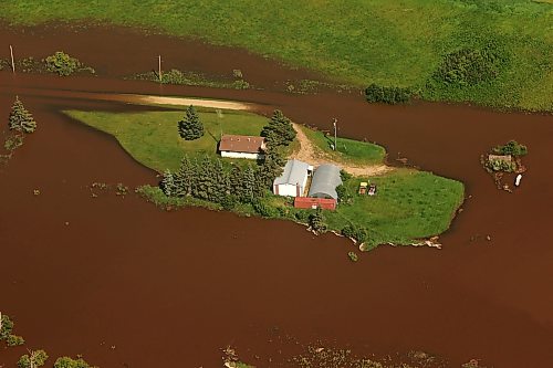 06072026
A home and farm sit on an island of dry land, surrounded by the floodwaters of the swollen Assiniboine River just west of Russell, Manitoba, as seen from the air on Monday. (Tim Smith/The Brandon Sun)