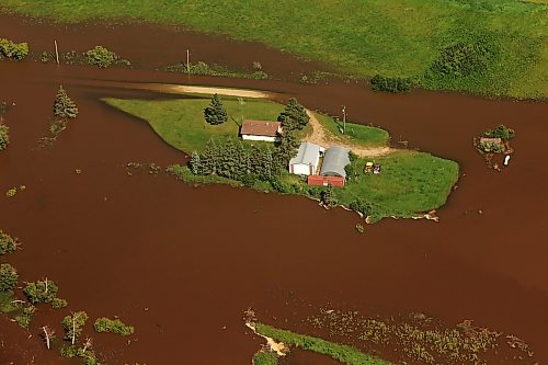 06072026
A home and farm sit on an island of dry land, surrounded by the floodwaters of the swollen Assiniboine River just west of Russell, Manitoba, as seen from the air on Monday. (Tim Smith/The Brandon Sun)