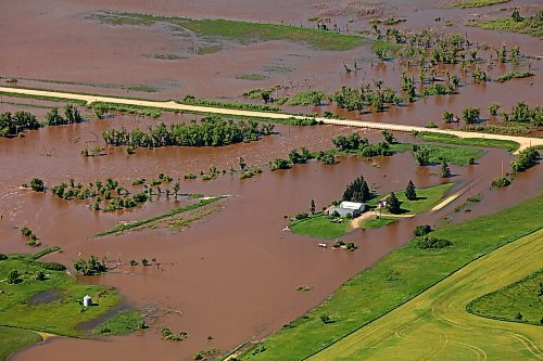 06072026
A home and farm sit on an island of dry land, surrounded by the floodwaters of the swollen Assiniboine River just west of Russell, Manitoba, as seen from the air on Monday. (Tim Smith/The Brandon Sun)