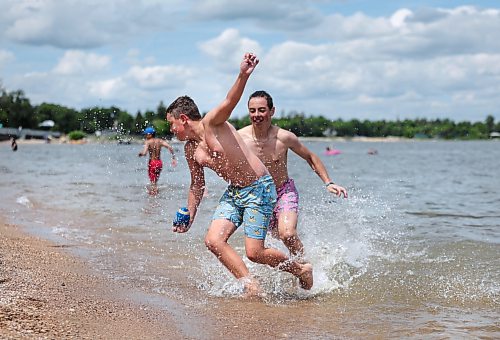 Ruth Bonneville / Free Press
Weather Standup Winnipeg Beach
Brothers Brady Wladyka, 14 (rear), and Cody Wladyka, 12, play tackle football at Winnipeg Beach while their family watches nearby, Tuesday. The Wladyka family, from Calgary, is spending part of its summer vacation at the family cottage.
July 7th, 2026