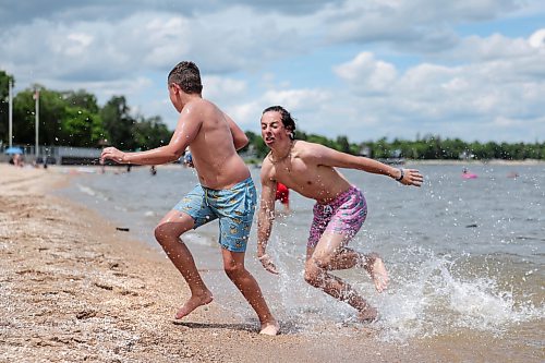 Ruth Bonneville / Free Press
Weather Standup Winnipeg Beach
Brothers Brady Wladyka, 14 (rear), and Cody Wladyka, 12, play tackle football at Winnipeg Beach while their family watches nearby, Tuesday. The Wladyka family, from Calgary, is spending part of its summer vacation at the family cottage.
July 7th, 2026