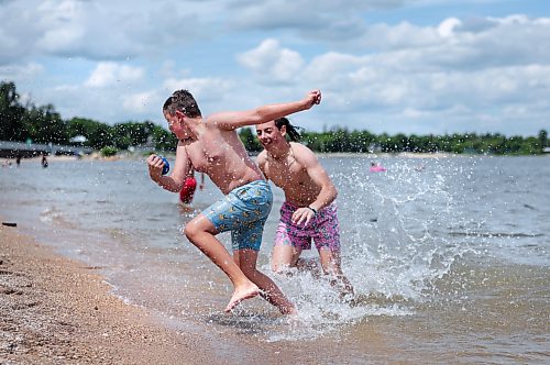 Ruth Bonneville / Free Press

Weather Standup Winnipeg Beach 

Brothers Brady Wladyka, 14 (rear), and Cody Wladyka, 12,  play tackle football at Winnipeg Beach while their family watches nearby, Tuesday. The Wladyka family, from Calgary, is spending part of its summer vacation at the family cottage.

July 7th,  2026
