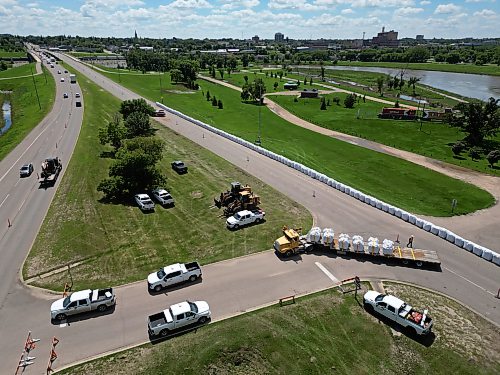 Workers install super sandbags along the southbound lanes of First Street North by Dinsdale Park in Brandon on Wednesday to create a dike as part of flood preparations. (Tim Smith/The Brandon Sun)