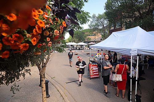 08072026
Brandonites take in the downtown summer market on Rosser Avenue on Wednesday. A portion of Rosser Avenue was closed to traffic for the market from 4:00 PM until 8:00 PM, and featured local artisans, food trucks, games, live music and other entertainent. The downtown market will run every Wednesday through July and August.  (Tim Smith/The Brandon Sun)
