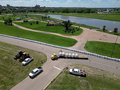 08072026
Workers install super sandbags along the southbound lanes of First Street North by Dinsdale Park in Brandon on Wednesday to create a dike as part of flood preparations. (Tim Smith/The Brandon Sun)
default