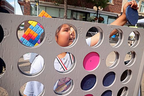 08072026
Savannah Nasekapow plays a large version of connect four with her sister Rosaleigh while taking in the downtown summer market on Rosser Avenue on Wednesday. A portion of Rosser Avenue was closed to traffic for the market from 4:00 PM until 8:00 PM, and featured local artisans, food trucks, games, live music and other entertainent. The downtown market will run every Wednesday through July and August.  (Tim Smith/The Brandon Sun)
