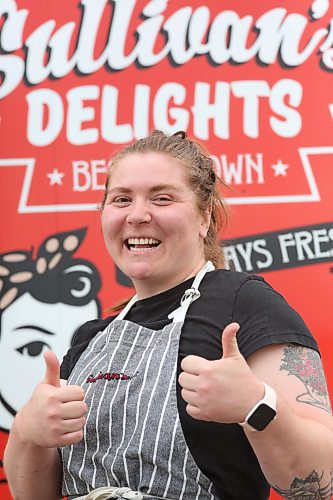 Sullivan’s Delights food truck owner and operator Baylie Gigolyk gives the thumbs up while standing outside of her business during a stop at Christie’s Office Supplies on Richmond Avenue on Thursday. (Matt Goerzen/The Brandon Sun)