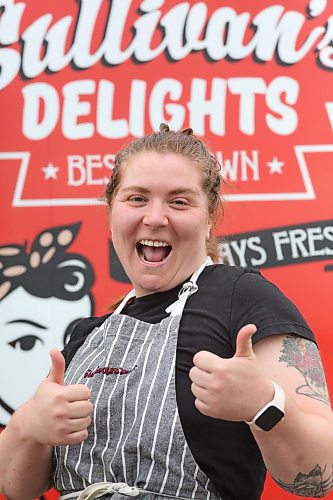 Sullivan’s Delights food truck owner and operator Baylie Gigolyk gives the thumbs up while standing outside of her business during a stop at Christie’s Office Supplies on Richmond Avenue on Thursday. (Matt Goerzen/The Brandon Sun)