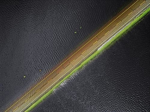 09072026
Water from the swollen Assiniboine River covers Highway 21 south of Sioux Valley Dakota Nation on Thursday. The section of the highway through the river valley is currently closed due to the flooding. 
(Tim Smith/The Brandon Sun)