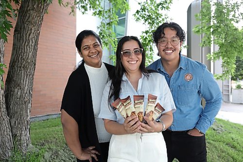 Ruth Bonneville / Free Press
ent - U of M food competition
Photo of a group of university students outside a Pilot test kitchen at the Richardson centre for food technology and research, U of M, holding a Rooster chocolate bar they are presenting at the upcoming completion, Friday.
Story: U of M finalists heading to product development competition with chocolate bar made from ROOTS
Names below:
Maria de Los Angeles Garofalo — White pants
Sherwin Santiano — blue shirt
Kemashalini Kirusnaruban — black pants and white shirt.
July 10th, 2026