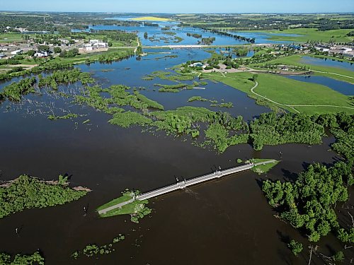 12072026
The foot bridge over the Assiniboine River at the Riverbank Discovery Centre is cut off on both sides by flood water on Sunday. (Tim Smith/The Brandon Sun)